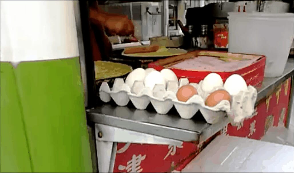 A carton of different colour eggs